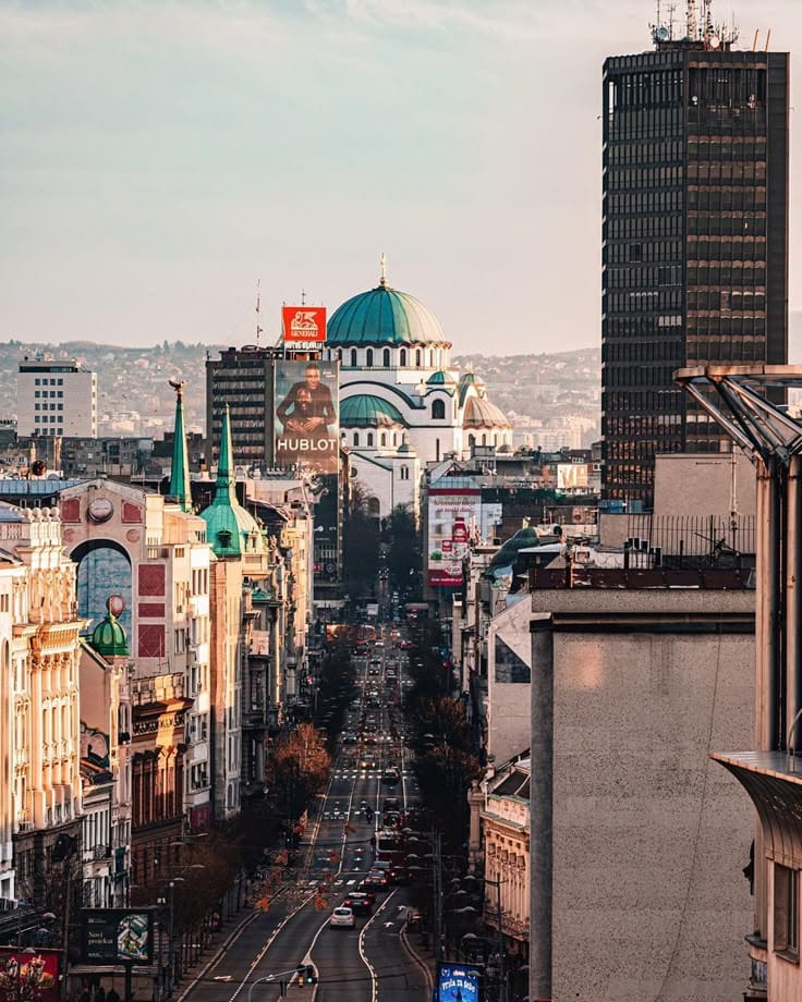 A Belgrade boulevard at dusk, looking toward the Church of Saint Sava